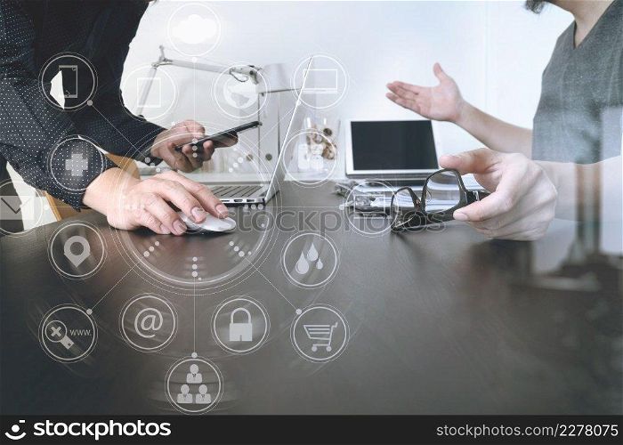 Business team meeting.Professional investor working new start up project and digital tablet docking keyboard and laptop computer with smart phone using and eyeglasses in modern office with virtual interface graphic icons network diagram