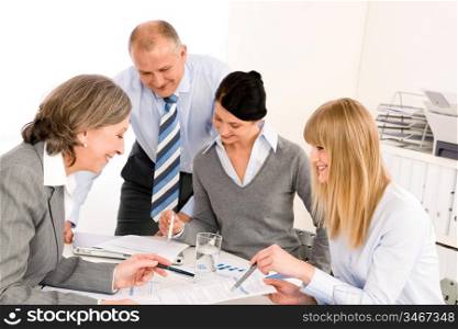 Business team meeting senior businesswoman with happy colleagues in office