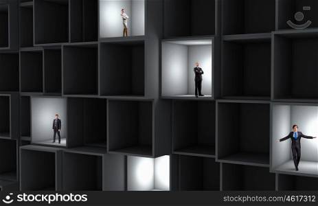 Business team. Miniatures of business people standing in cube