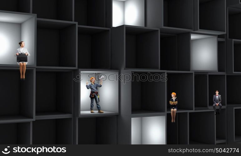 Business team. Miniatures of business people standing in cube