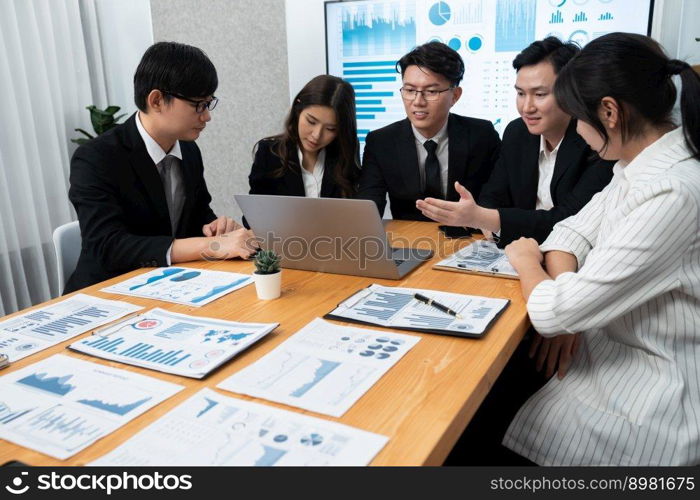 Business team of financial data analysis meeting with business intelligence, report paper and dashboard on laptop for marketing strategy. Business people working together to promote harmony in office.. Business team of financial data analysis meeting report paper in harmony office.