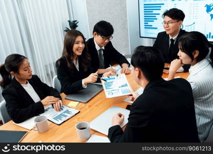 Business team of financial data analysis meeting with business intelligence, report paper and dashboard on laptop for marketing strategy. Business people working together to promote harmony in office.. Business team of financial data analysis meeting report paper in harmony office.