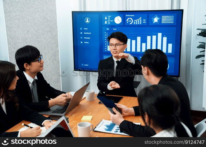 Business team of financial data analysis meeting with business intelligence, report paper and dashboard on laptop for marketing strategy. Business people working together to promote harmony in office.. Business team of financial data analysis meeting report paper in harmony office.