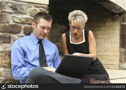 Business team on location with laptop.