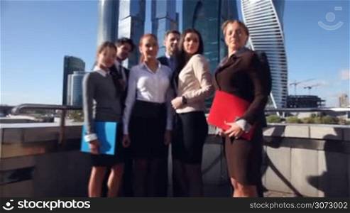 Business team outside office on skyscrapers background