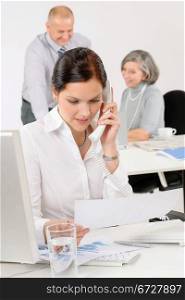 Business team pretty businesswoman calling phone happy colleagues around table