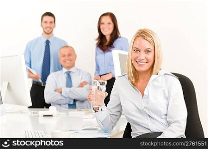 Business team pretty young businesswoman portrait with colleagues around table