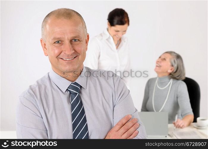 Business team senior businessman with attractive female happy colleagues