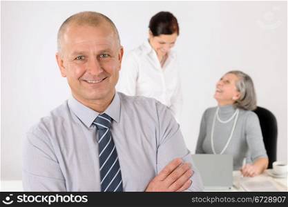 Business team senior businessman with attractive female happy colleagues