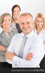 Business team senior businessman with attractive happy colleagues in office