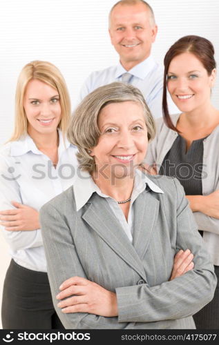 Business team senior businesswoman with attractive happy colleagues in office