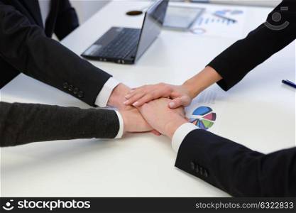 Business team showing unity with their hands together