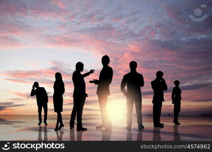 Business team. Silhouettes of business people standing in line