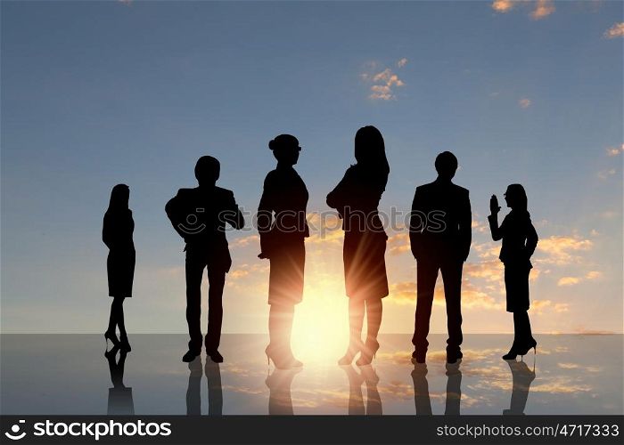 Business team. Silhouettes of business people standing in line