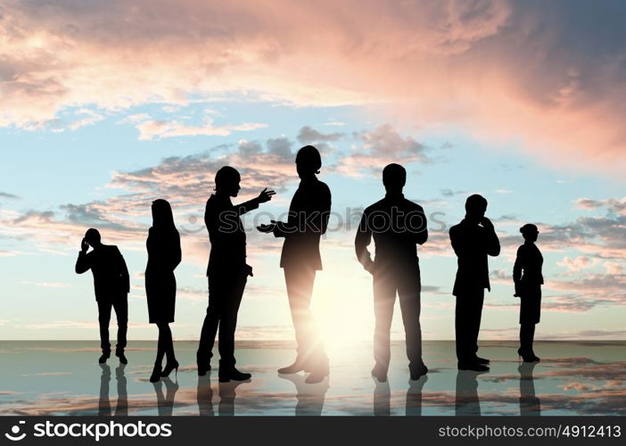 Business team. Silhouettes of business people standing in line