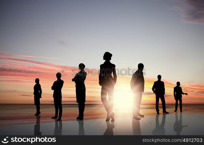 Business team. Silhouettes of business people standing in line