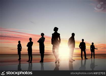 Business team. Silhouettes of business people standing in line