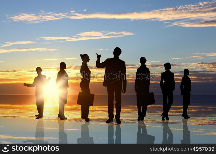 Business team. Silhouettes of business people standing in line