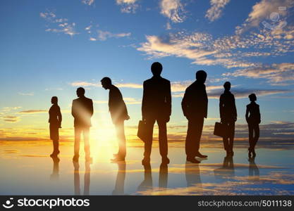 Business team. Silhouettes of business people standing in line