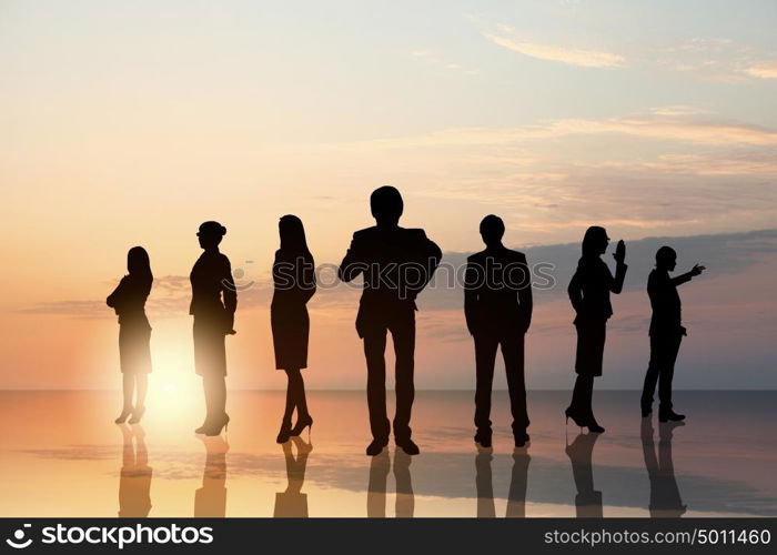 Business team. Silhouettes of business people standing in line