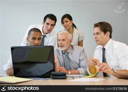 Business team sitting at a computer