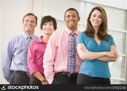 Business team standing indoors smiling