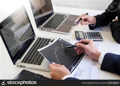 Business Team trader or broker Investment Entrepreneur colleagues working discussing and analysis graph stock market trading with forex chart data, financial, selling and buying concept.