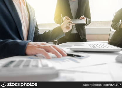 Business team two colleagues discussing new plan financial graph data on office table with laptop.