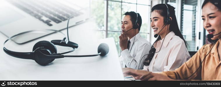 Business team wearing headset working actively in office . Call center, telemarketing, customer support agent provide service on telephone video conference call.. C1-C2-C3