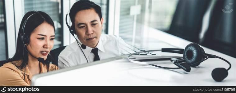 Business team wearing headset working actively in office . Call center, telemarketing, customer support agent provide service on telephone video conference call.. Business team wearing headset working actively in office