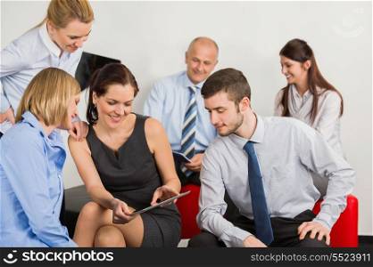 Business team with digital tablet discussing in office