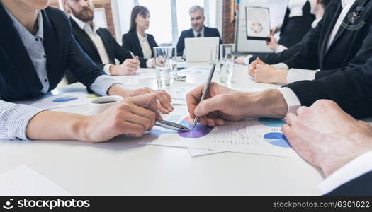 Business team with reports. Business people team discussing financial stockmarket charts in office