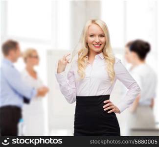 business, team work and people concept - smiling businesswoman, student or secretary over group of colleagues in office background