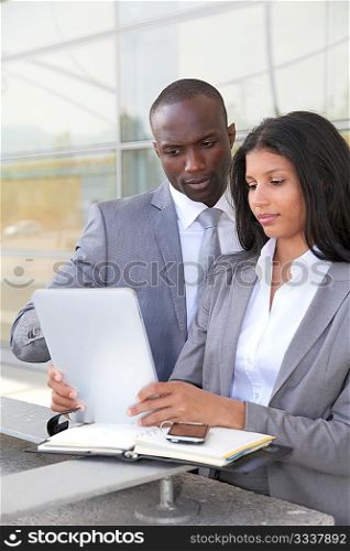 Business team working on electronic tablet