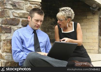 Business team working on location with laptop.