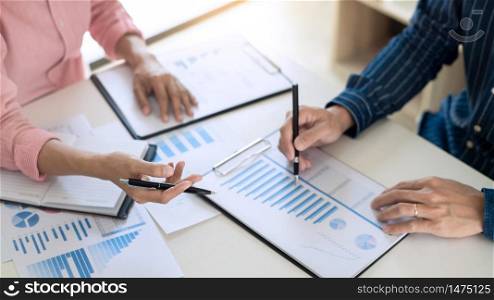 Business team working with plan on office desk with new startup project analyzing financial document data charts and graphs in Meeting and successful teamwork Concept