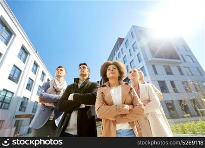 business, teamwork and leadership concept - international group of people on city street. international group of people on city street