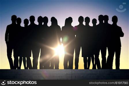business, teamwork and people concept - business people silhouettes on stairs over sun light background