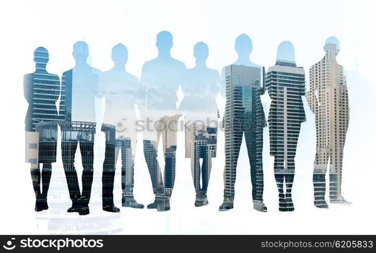 business, teamwork and people concept - business people silhouettes over city background with double exposure effect