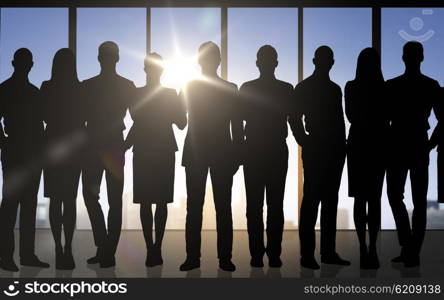 business, teamwork and people concept - business people silhouettes over office background