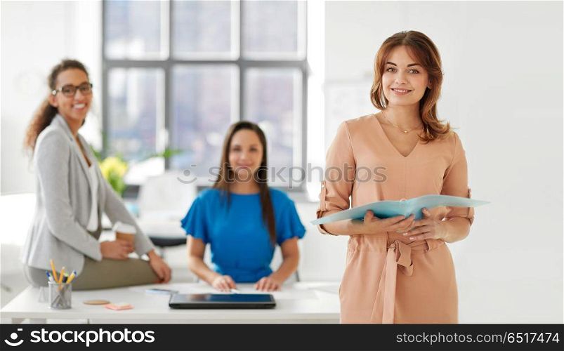 business, teamwork and people concept - businesswoman with folder at office. businesswoman with folder at office. businesswoman with folder at office