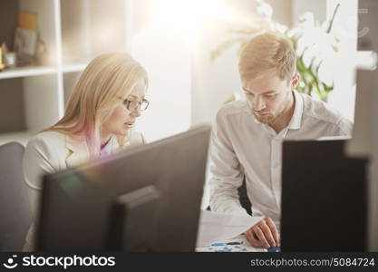 business, teamwork and people concept - creative team discussing papers at office table. business team discussing papers at office table. business team discussing papers at office table