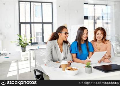business, teamwork and people concept - female team or businesswomen discussing papers at office. businesswomen discussing papers at office. businesswomen discussing papers at office