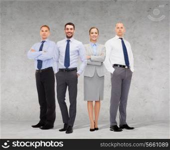 business, teamwork and people concept - group of smiling businessmen over gray concrete wall background