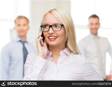 business, teamwork and people concept - smiling businesswoman, student or secretary in eyeglasses calling on smartphone over office and group of colleagues background