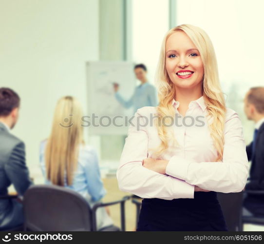 business, teamwork and people concept - smiling businesswoman, student or secretary over office and group of colleagues background