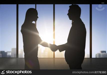 business, teamwork, partnership, cooperation and people concept - business people shaking hands over office background