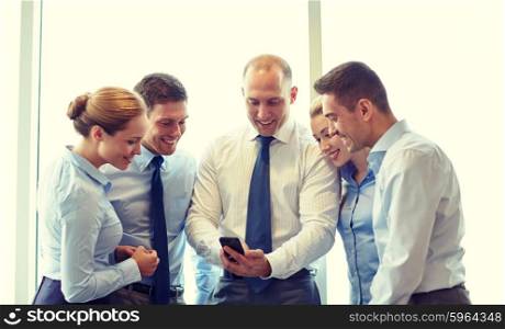 business, teamwork, people and technology concept - business team with smartphone meeting in office