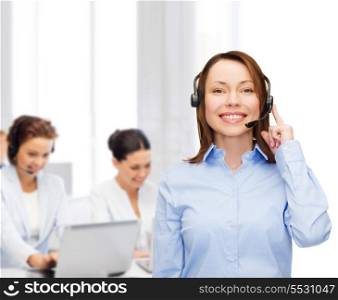 business, technology and call center concept - friendly female helpline operator with headphones at office