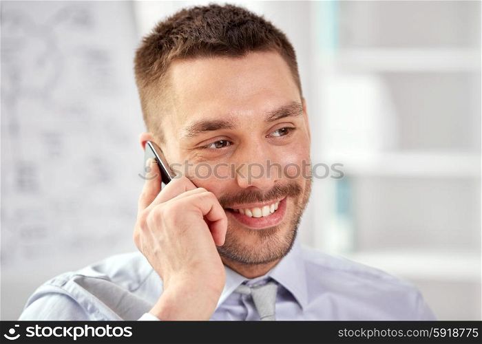 business, technology and communication concept - young smiling businessman calling on smartphone
